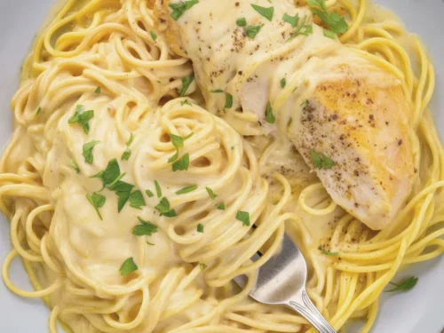 Crockpot angel chicken served over angel hair pasta with creamy sauce.