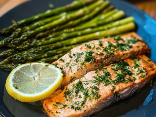 Plate of Keto Lemon Garlic Salmon with Asparagus garnished with lemon slices