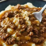 Delicious ground beef gravy over creamy mashed potatoes, a comforting meal.