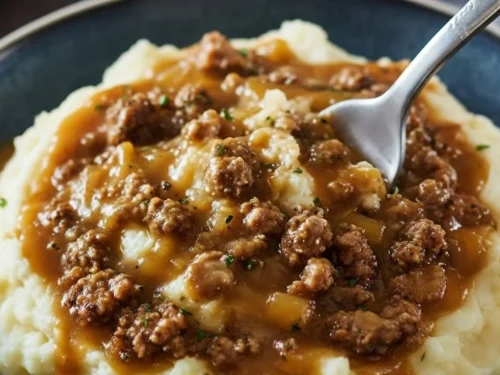 Delicious ground beef gravy over creamy mashed potatoes, a comforting meal.