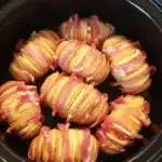 Plate of Hunters Chicken served with Hassleback potatoes, garnished with herbs.