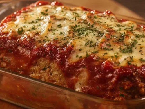 Delicious Parmesan Meatloaf on a plate garnished with herbs