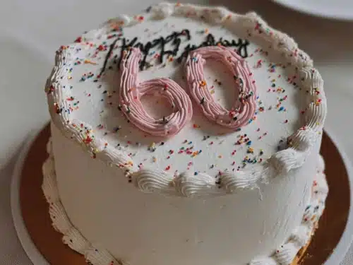 Elegant 60th birthday cake design with number decor and simple aesthetics.