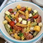 Bowl of classic pasta salad with vegetables and dressing