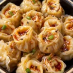Delicious dumplings served with savory sauce for a tasty meal.