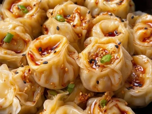 Delicious dumplings served with savory sauce for a tasty meal.