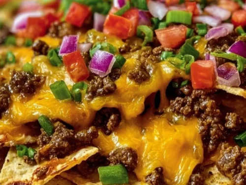 Delicious Epic Beef Nachos Supreme topped with cheese, beef, and fresh ingredients