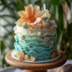 Beautiful ocean-inspired cake decorated with blue waves and seashells.