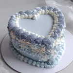 Vintage blue heart cake with bows for a sweet 16 birthday celebration