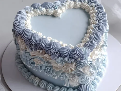 Vintage blue heart cake with bows for a sweet 16 birthday celebration