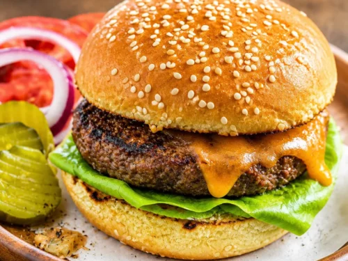Perfectly grilled burgers with toppings of pineapple, grilled onions, and avocado cream.