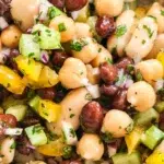 Colorful 3 bean salad served in a bowl, featuring beans, vegetables, and dressing