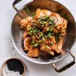 Delicious baked teriyaki chicken thighs garnished with green onions