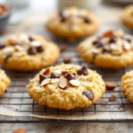 Chewy coconut almond joy cookies topped with dark chocolate chips and whole toasted almonds.